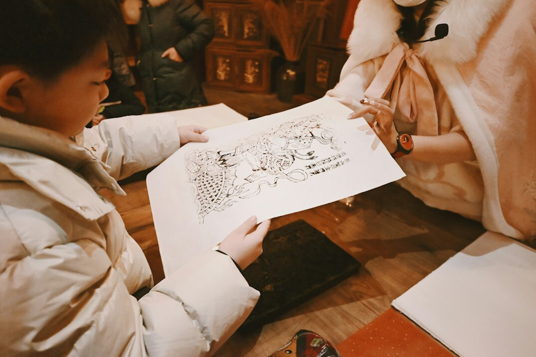 Small research team discussing audience survey results around a table with printed charts