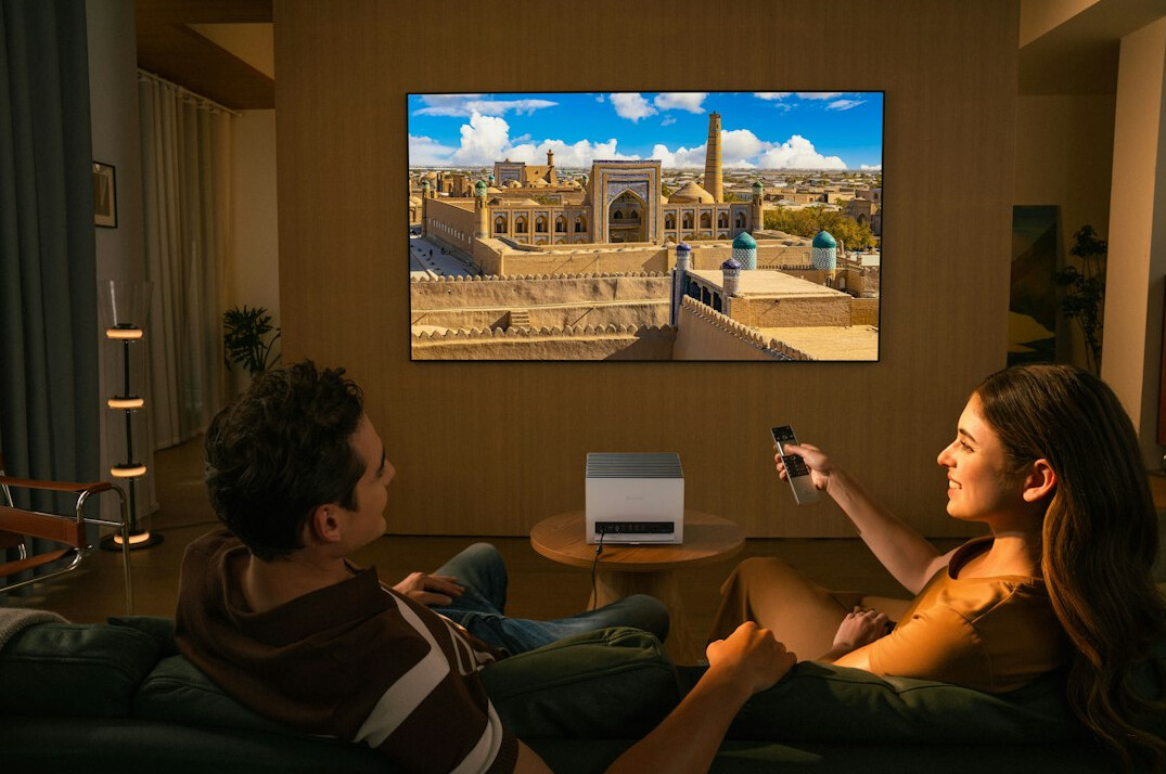 Family watching television together in a living room in the evening